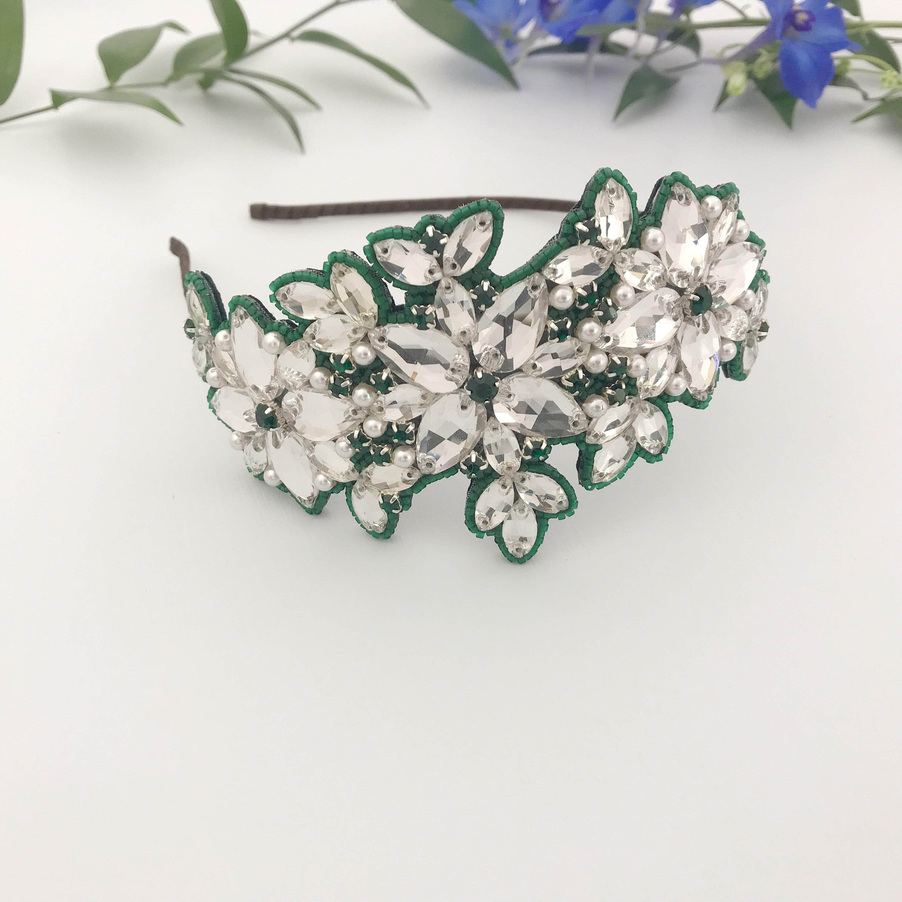 Large crystal hair band with green beading around the outside