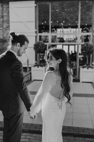 black and white image of kelly and stephen holding hands