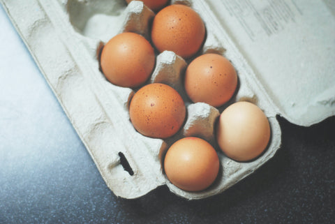 A carton of six brown eggs