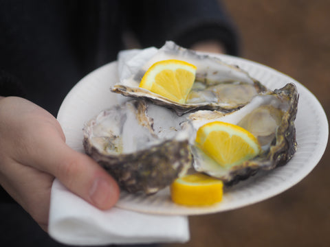 Three oysters with lemon slices on them