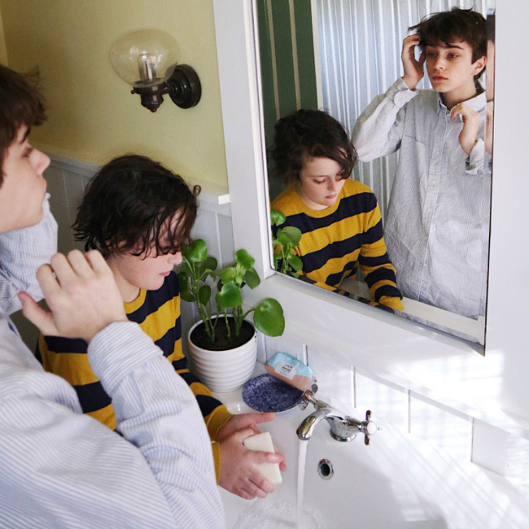 Two boys getting ready in front of the mirror