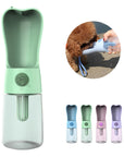 Green Heart™ - Pet Water Bottle with also a blue, green, pink and purple Heart™ - Pet Water Bottle on a white background and a small brown dog drinking water out of a blue Heart™ - Pet Water Bottle on a vivid background.