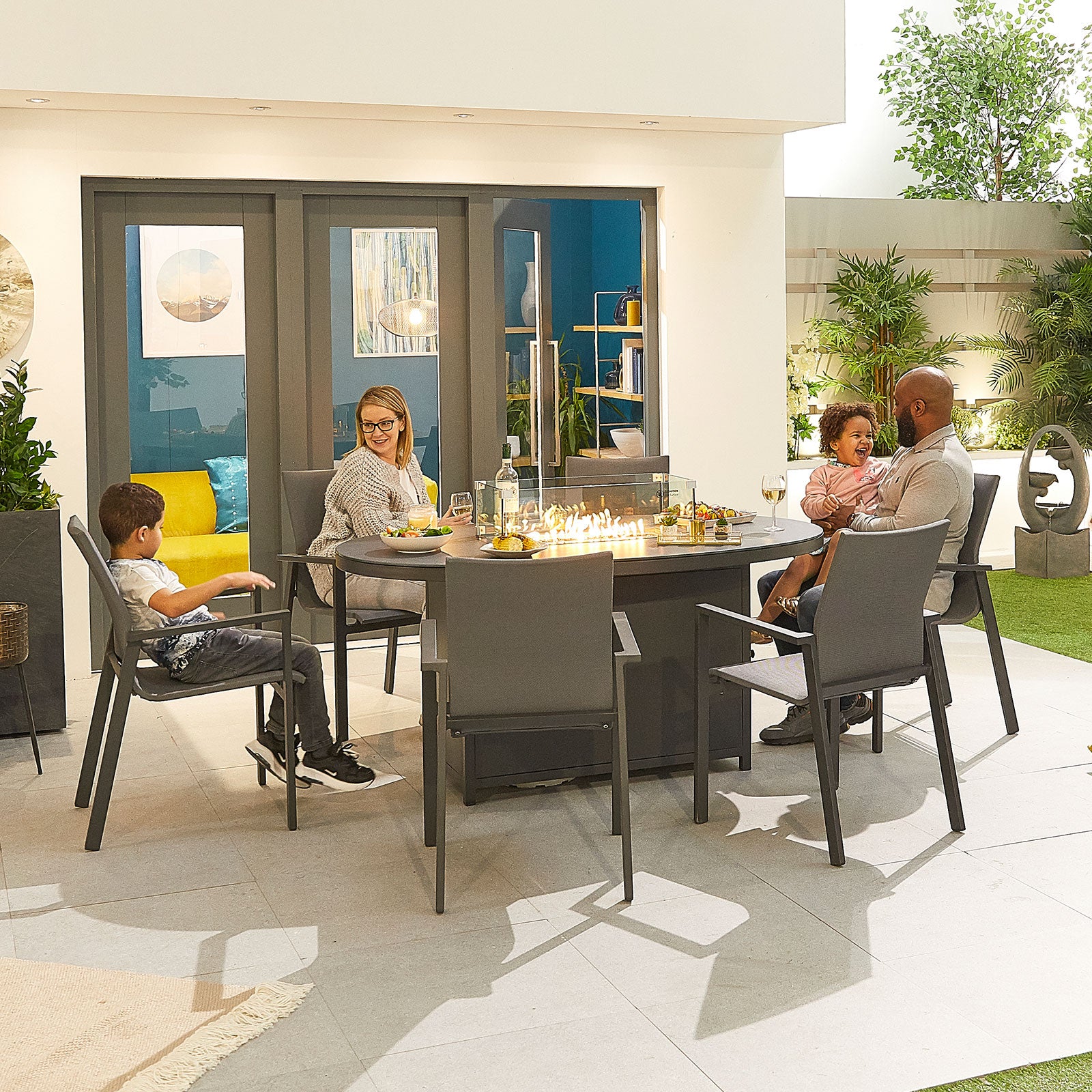 An image of Nova - Roma 6 Seat Oval Dining Set with Firepit - Grey