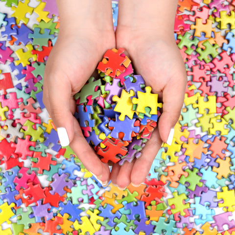 Handful of colorful jigsaw puzzle pieces | Blue Kazoo
