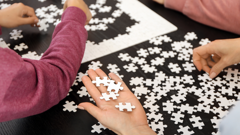 group putting together jigsaw puzzle