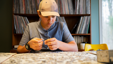 teenage doing puzzle after school