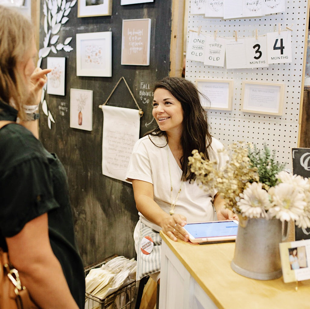 coley kuyper talking to customers at junk in the trunk vintage market