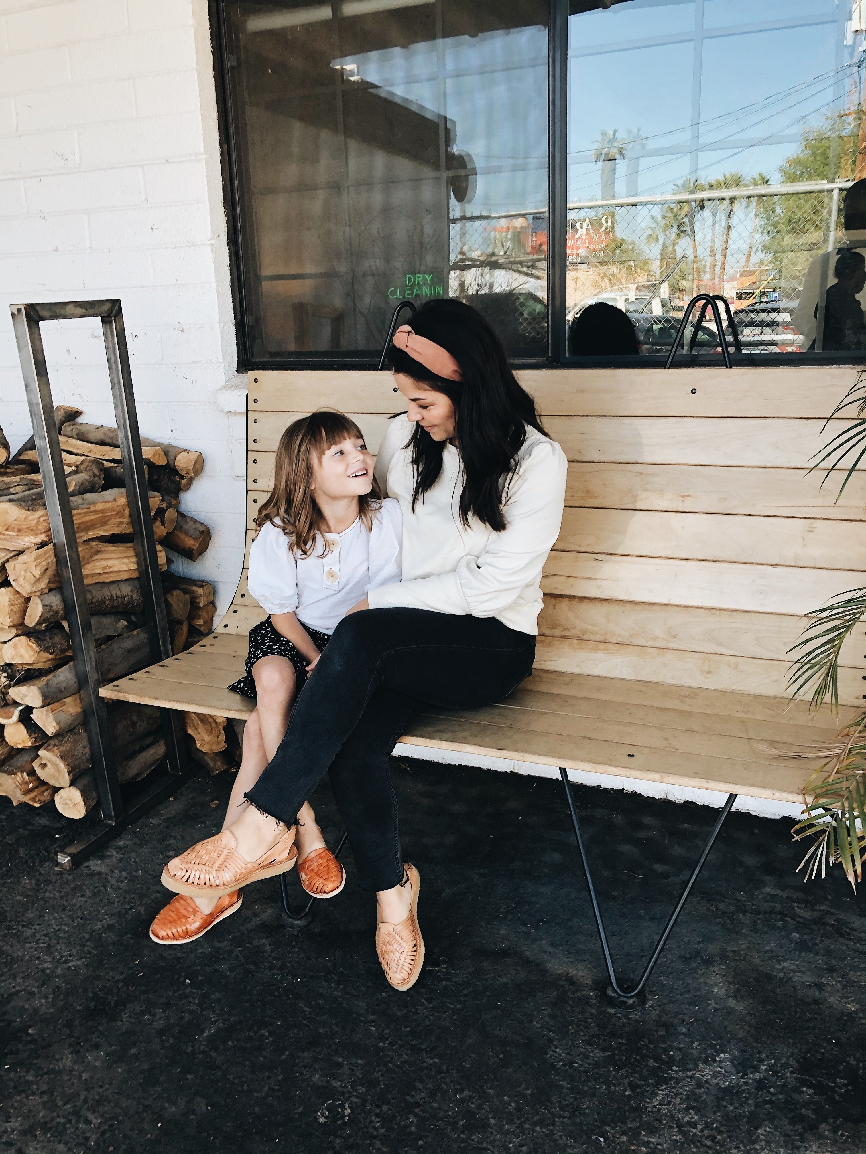 mother and daughter sitting on bench together