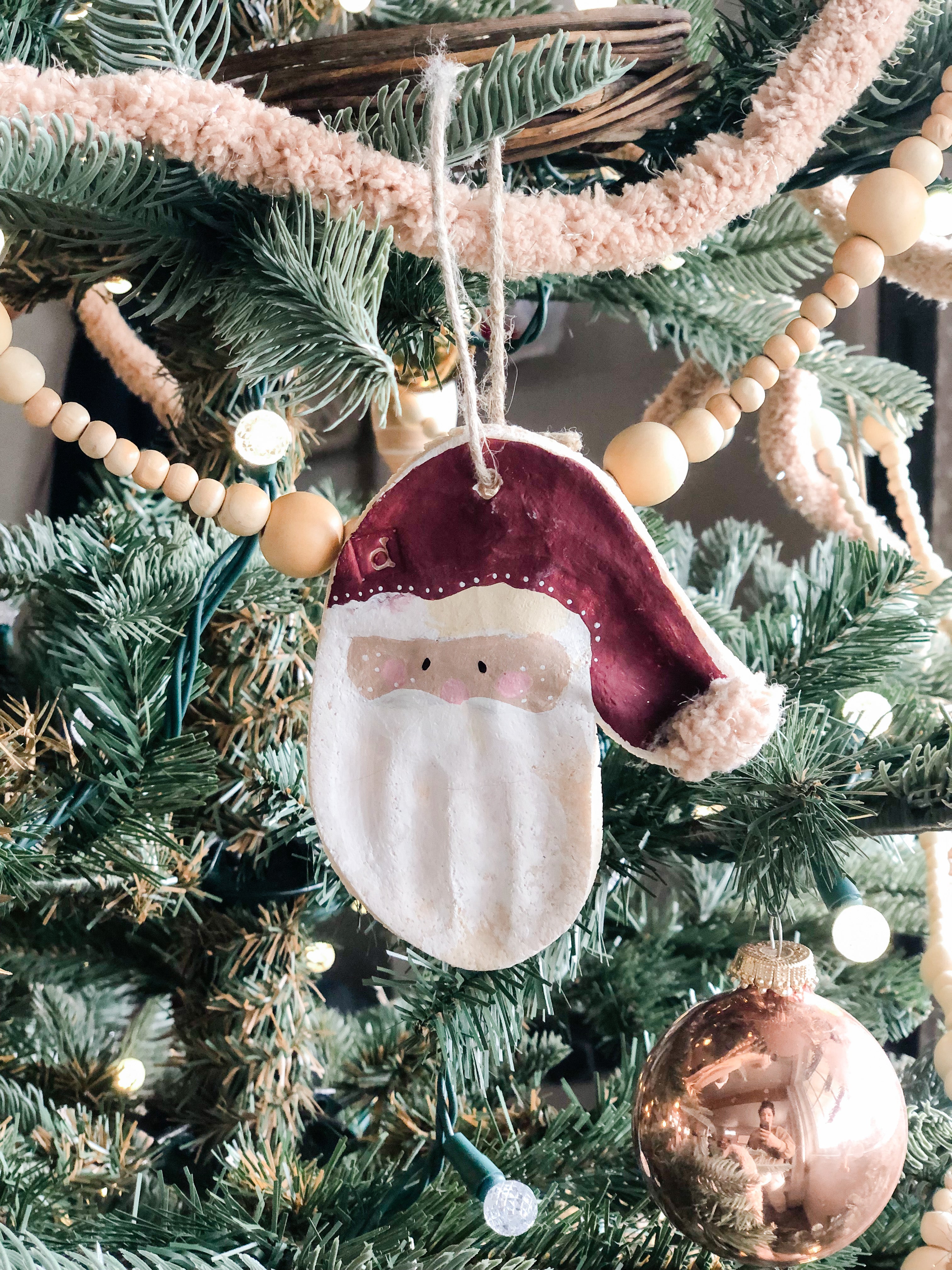 santa handprint ornament on christmas tree