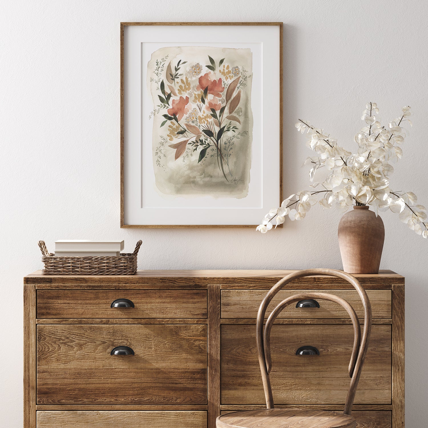 floral artwork framed above a dresser