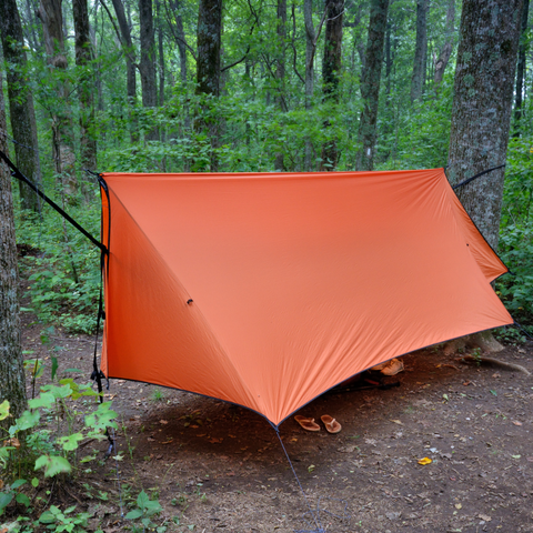 Putting up a fly shelter in your campsite will keep you and your gear dry.