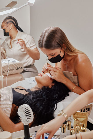 Lash Technician applying eyelash extensions to natural eyelashes