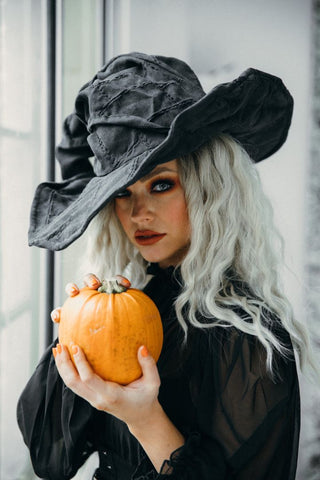 Witch costume and pumpkin for Halloween for a Halloween party
