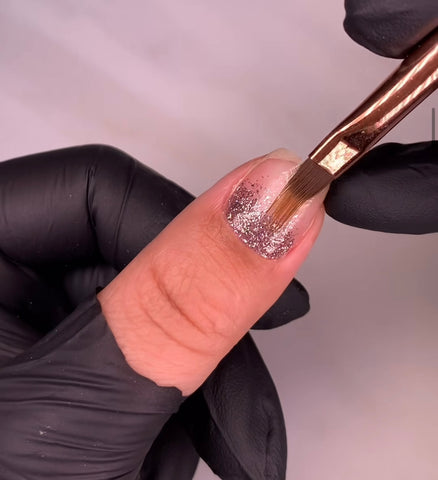Ombre nail brush being used to create ombre nails