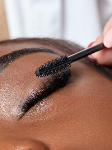 Close-up of classic lash extensions and lash brush