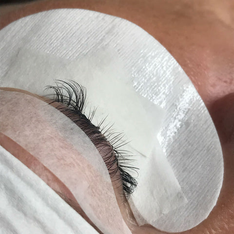 Natural lashes with lash tape dividing the layers of eyelashes