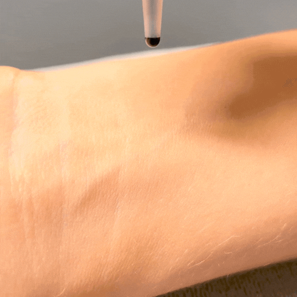 Lash Technician patch testing eyelash extension glue on a lash client's skin