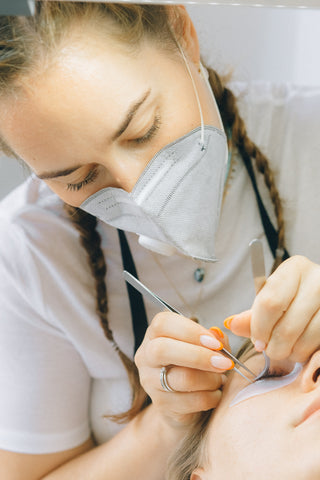 lash artist performing eyelash extension treatment