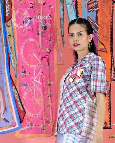 An article highlighting the influence of Jakarta's traditional dish, Asinan Betawi, on the fashion designs of Tioria by Caramia. The piece vividly describes the connection between the dish's rich, diverse flavors and the brand's fusion of Indonesian cultural heritage with contemporary fashion elements