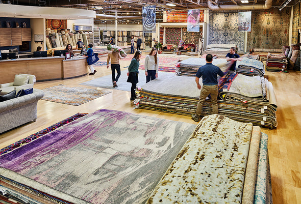 Landry and Arcari Framingham Showroom with Customers browsing through rug piles
