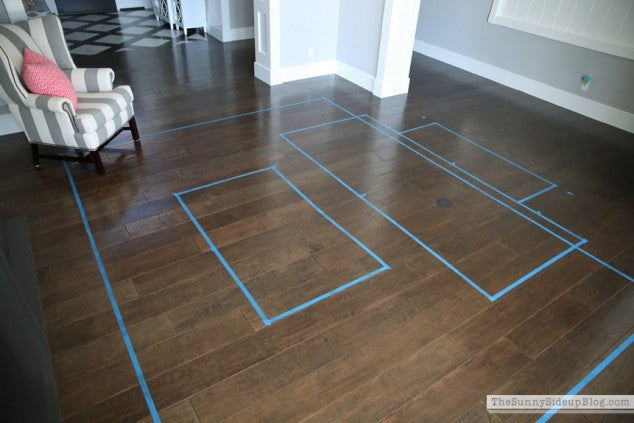 painters tape on the floor to visualize a rug
