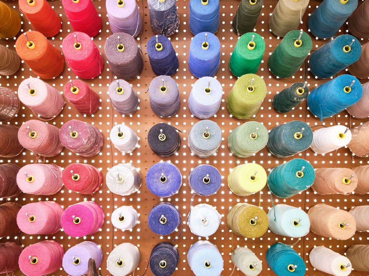 spools of carpet colors for hand serging