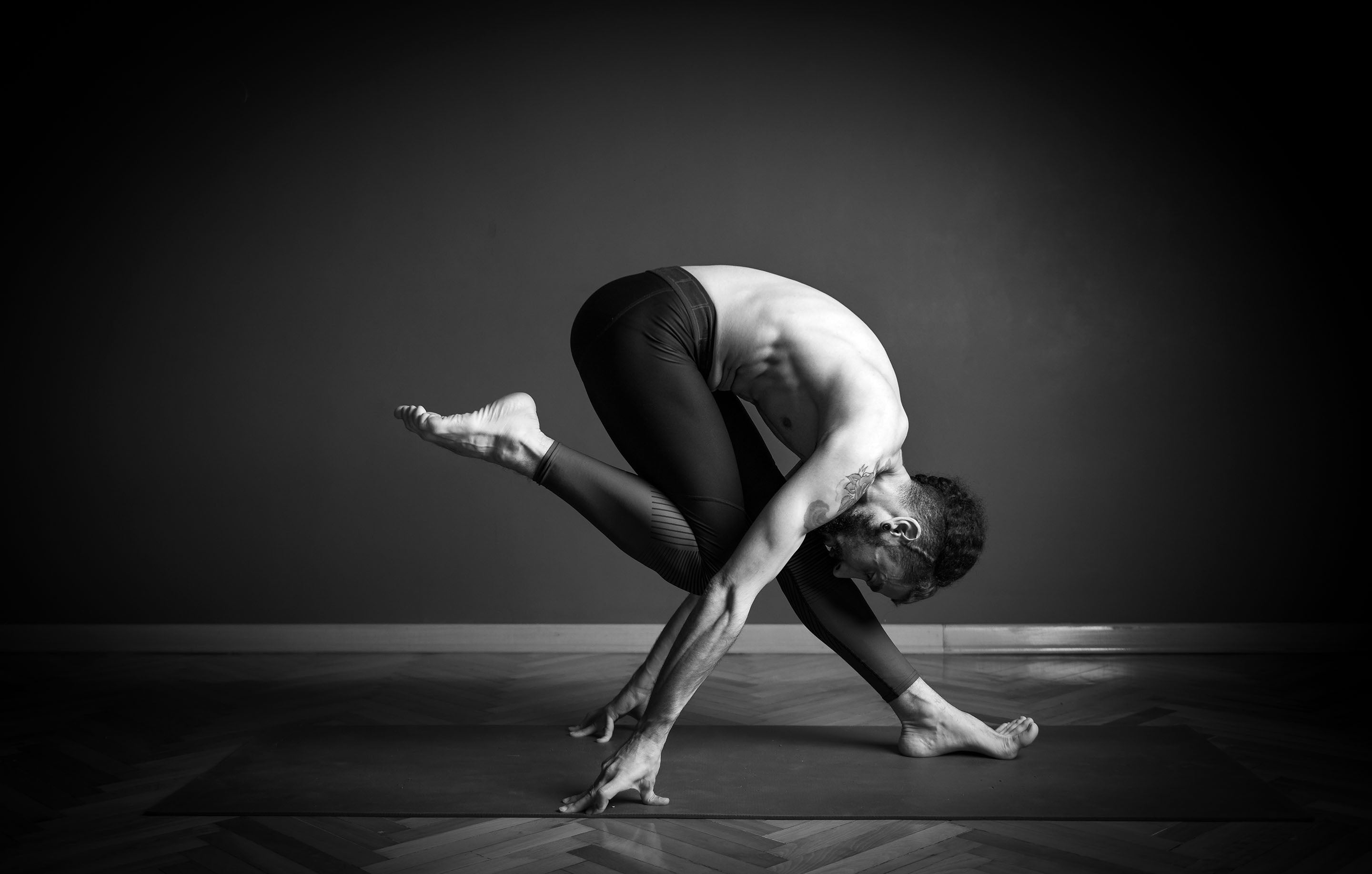 Extremely flexible yogi in a cool pose black and white | Asana Singapore - Challenge The Norm