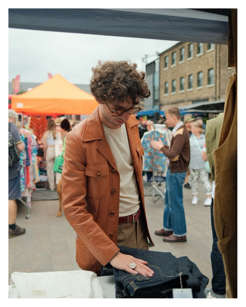 A man looking at jeans at Classic Car Boot Sale 2023