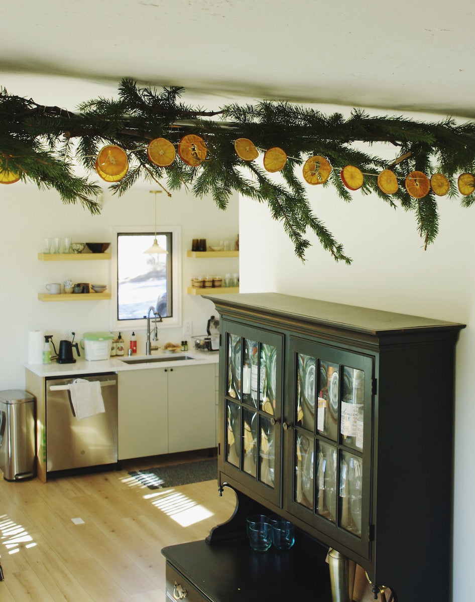 Orange garland intwined with a traditional pine garland