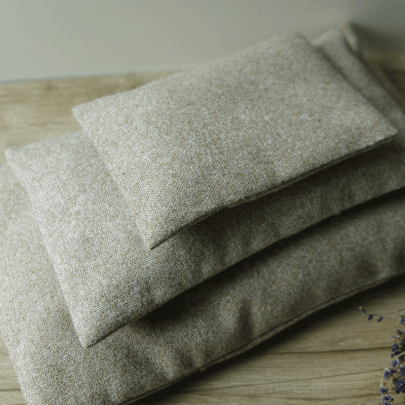 Stack of three tan linen lavender pillows