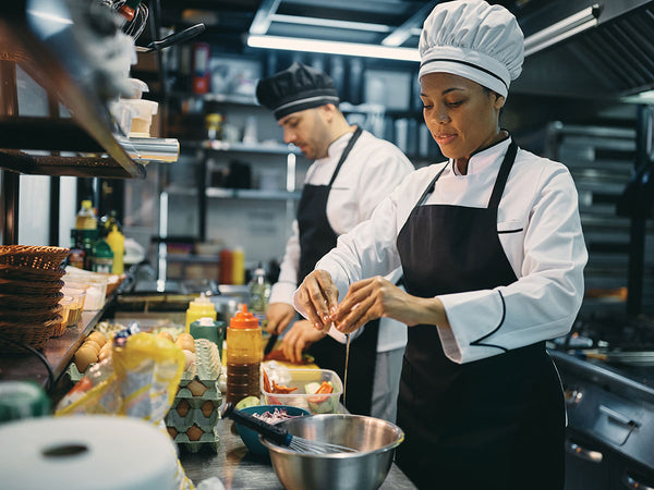 Chefs in kitchen with correct uniform