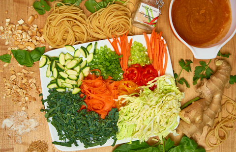 The dish, deconstructed so you can see all the ingredients: fresh basil, peanuts, sesame, noodles, carrots, cabbage, kale, zucchini, bell pepper, green onion, ginger, garlic, Thai Ginger Lemongrass salt