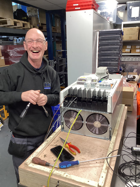 an edc variable speed drive service engineer reapiring an inverter in our workshop