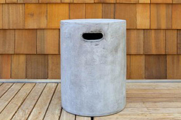 An image of the Round Urban Concrete Stool from Creative Living's collection of outdoor furniture against a background of wood siding.