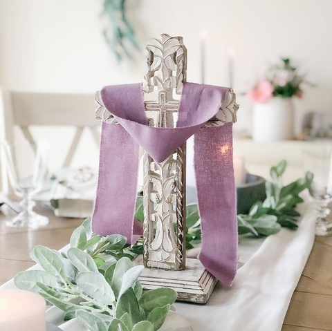 A table and cross decorated for Easter