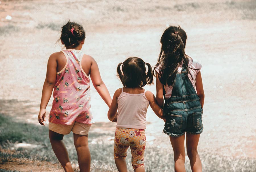 Three little girls standing together