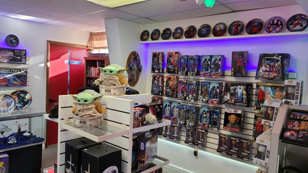 A wall covered in various collectibles from Star Wars. 