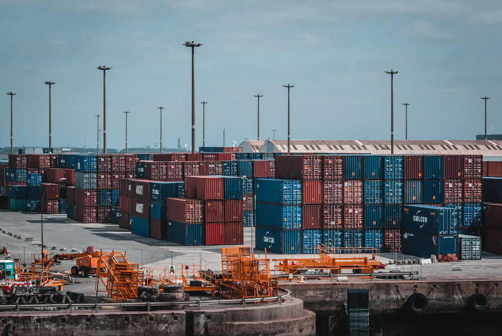 A side view of shipping containers at port. 