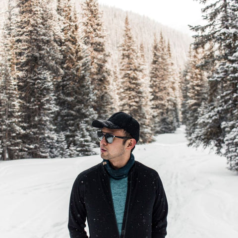 Khai on a snowy trail wearing Wilderness Expedition Full Zip