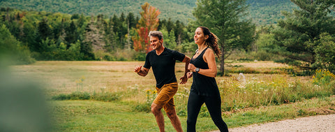 male and female running wearing a v-neck and tank top that is woolverino micro weight fabric breathable moisture wicking and anti odor