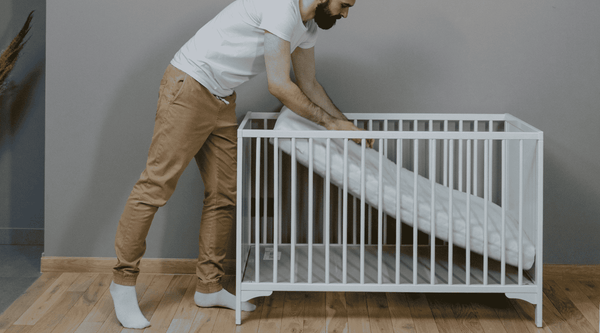 man fixing baby crib