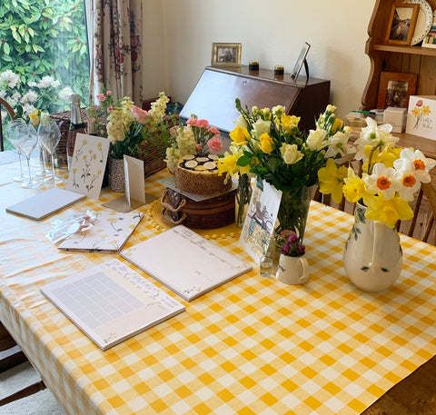 Dining table with flowers all over and yellow table cloth