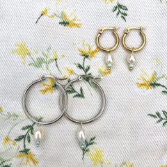 dainty earrings on material 