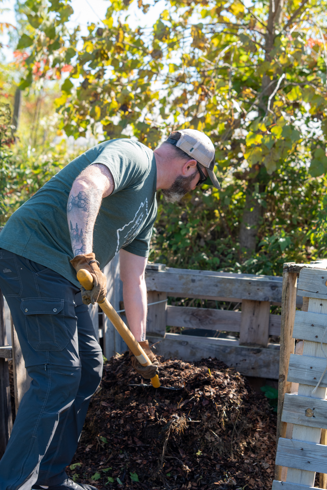 Person shovelling compost on Pott Farms