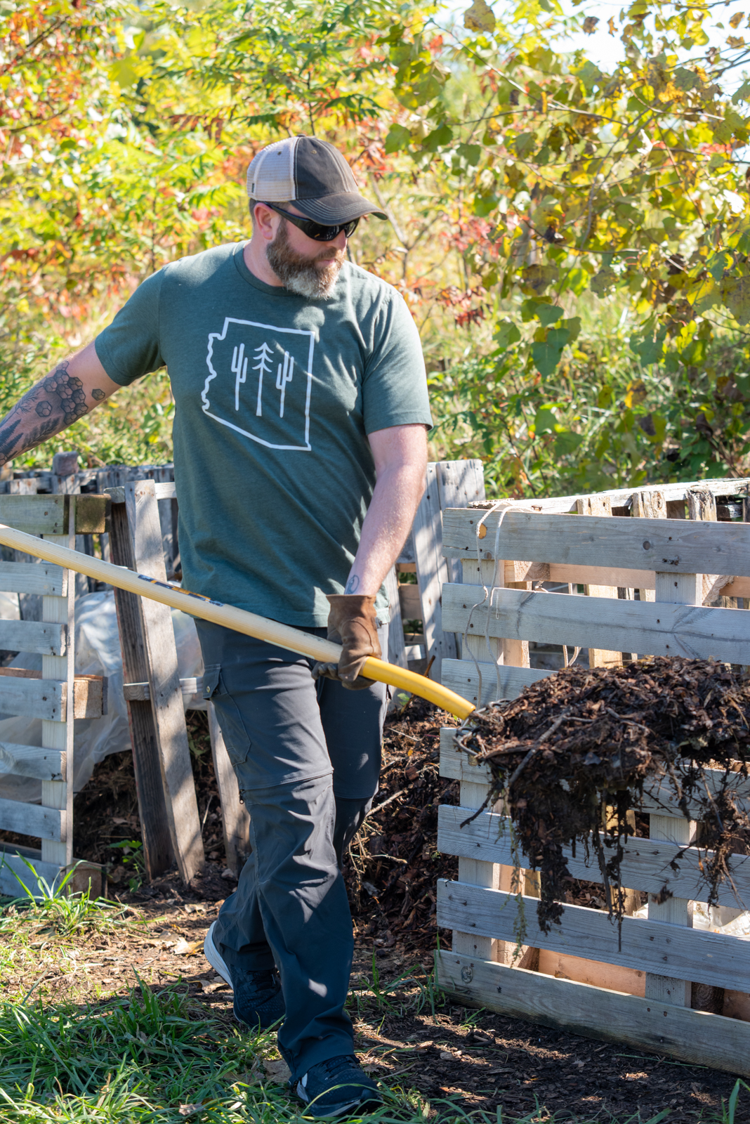 Man shovelling compost on Pott Farms