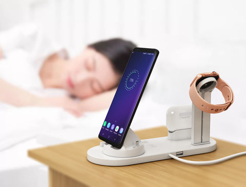 a 3in1 fast charger is charging phone, airpods and apple watch.