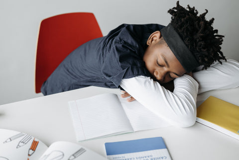 Child sleeping at desk