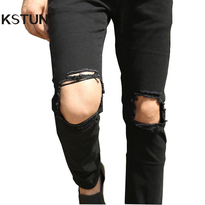 black ripped jeans at knee