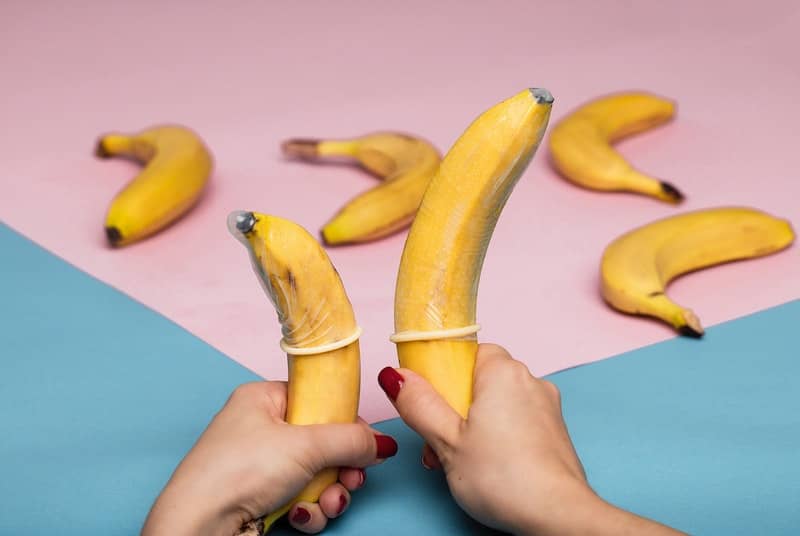 2 bananas with condoms on promoting safe sex during pegging