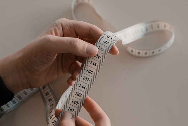 Man holding fabric tape measure for measuring your penis